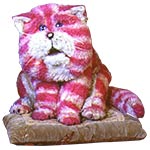 Bagpuss, a pink and white striped, saggy old cloth cat, sitting on his cushion.