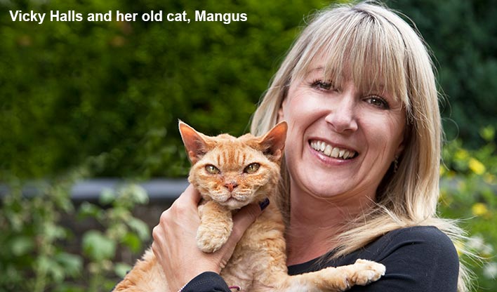 Vicky Halls holding her old ginger cat Magnus.