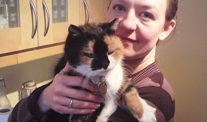 Sheppy and Tara Sheppy, an older tortoiseshell and white cat in her owners arms.