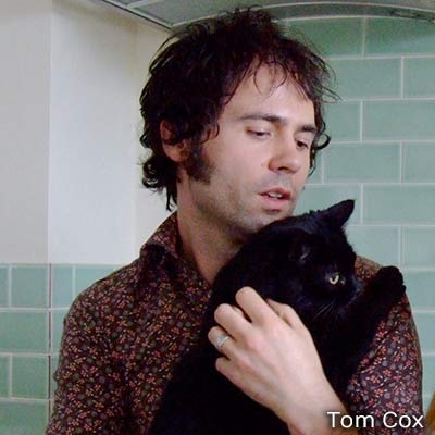 Tom Cox with a black cat.