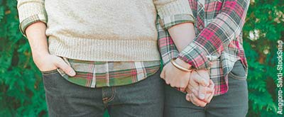 Couple holding hands.